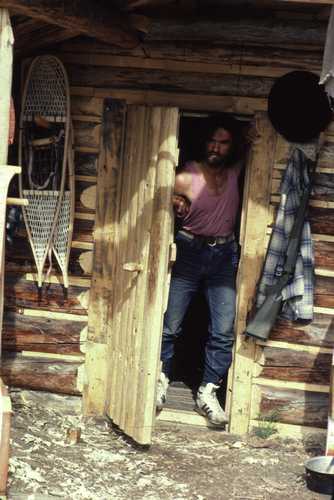 man at cabin door