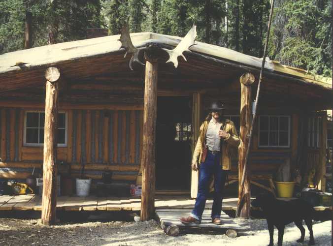 man at front entrance to cabin